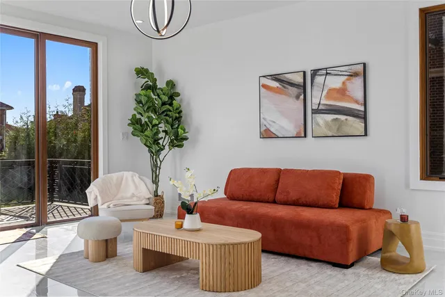 a living room with furniture a lamp and a potted plant