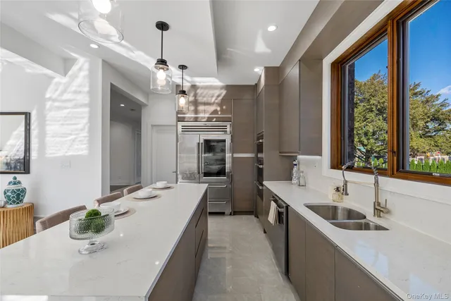 a large white kitchen with a large window