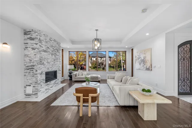 a living room with furniture a fireplace and a large window