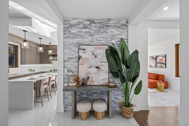 a living room with furniture a potted plant and a fireplace