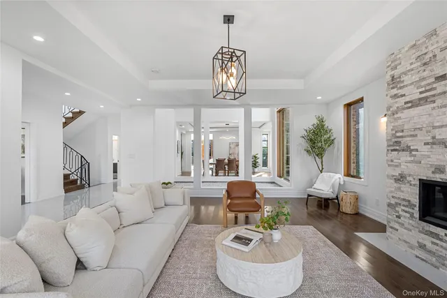 a living room with fireplace furniture and a chandelier