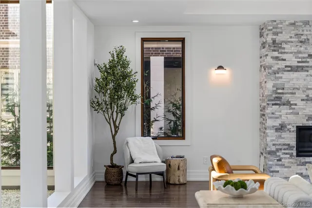 a living room with furniture and a potted plant