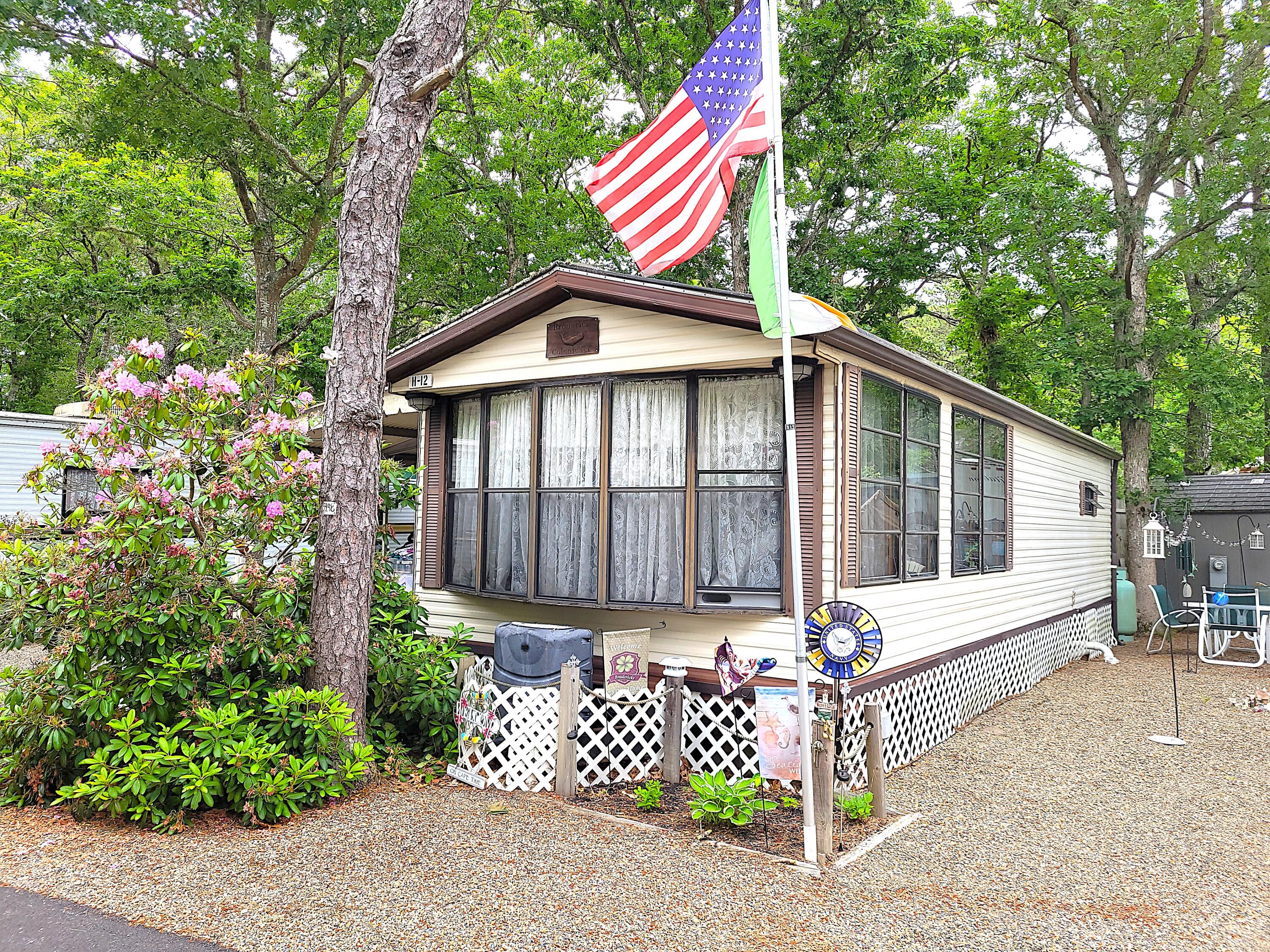310 Old Chatham Road, Unit H12 South Dennis, MA 02660 - Photo 2 of 55 a front view of a house with a yard