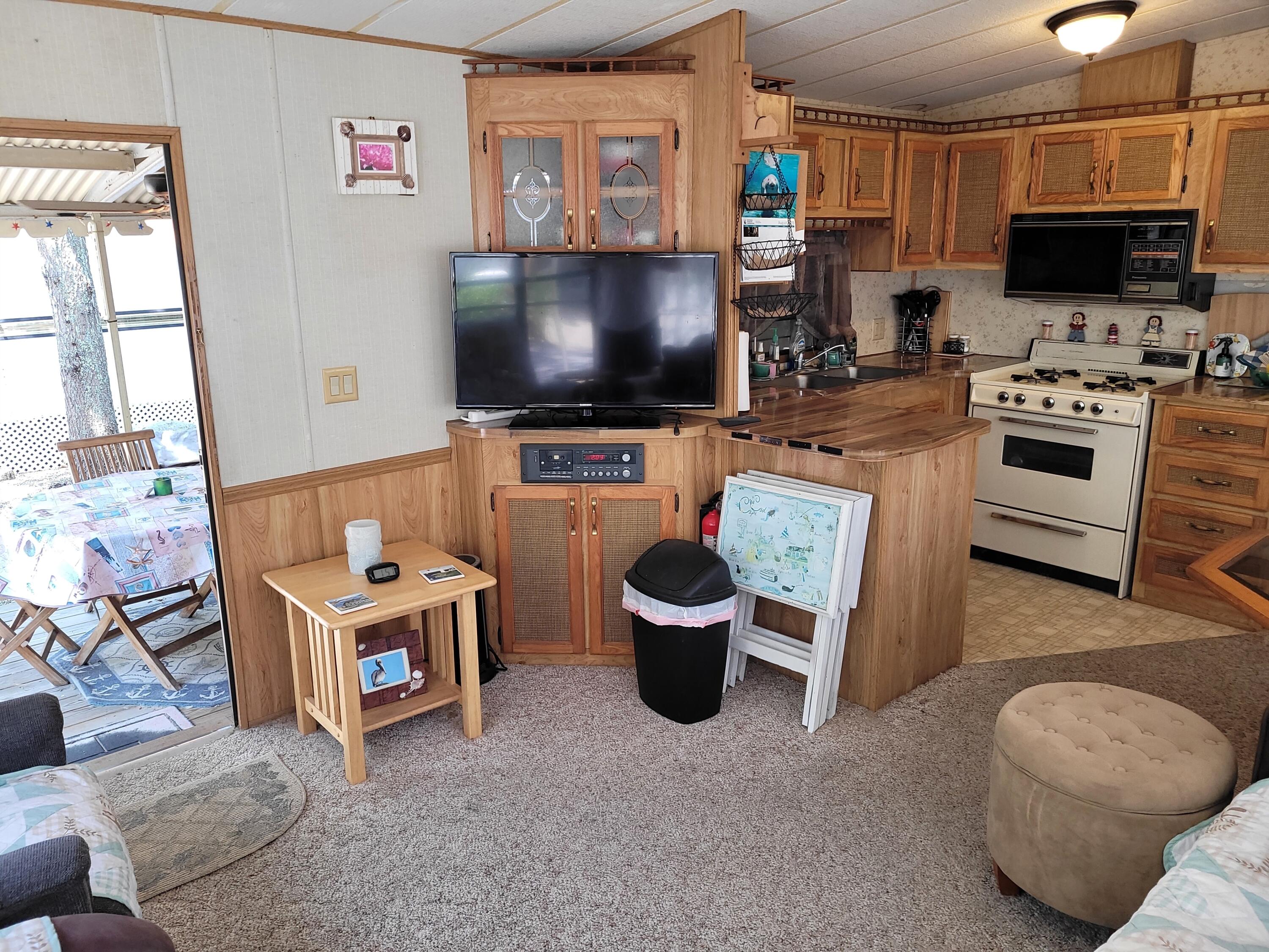 310 Old Chatham Road, Unit H12 South Dennis, MA 02660 - Photo 27 of 55 a living room with furniture and a flat screen tv