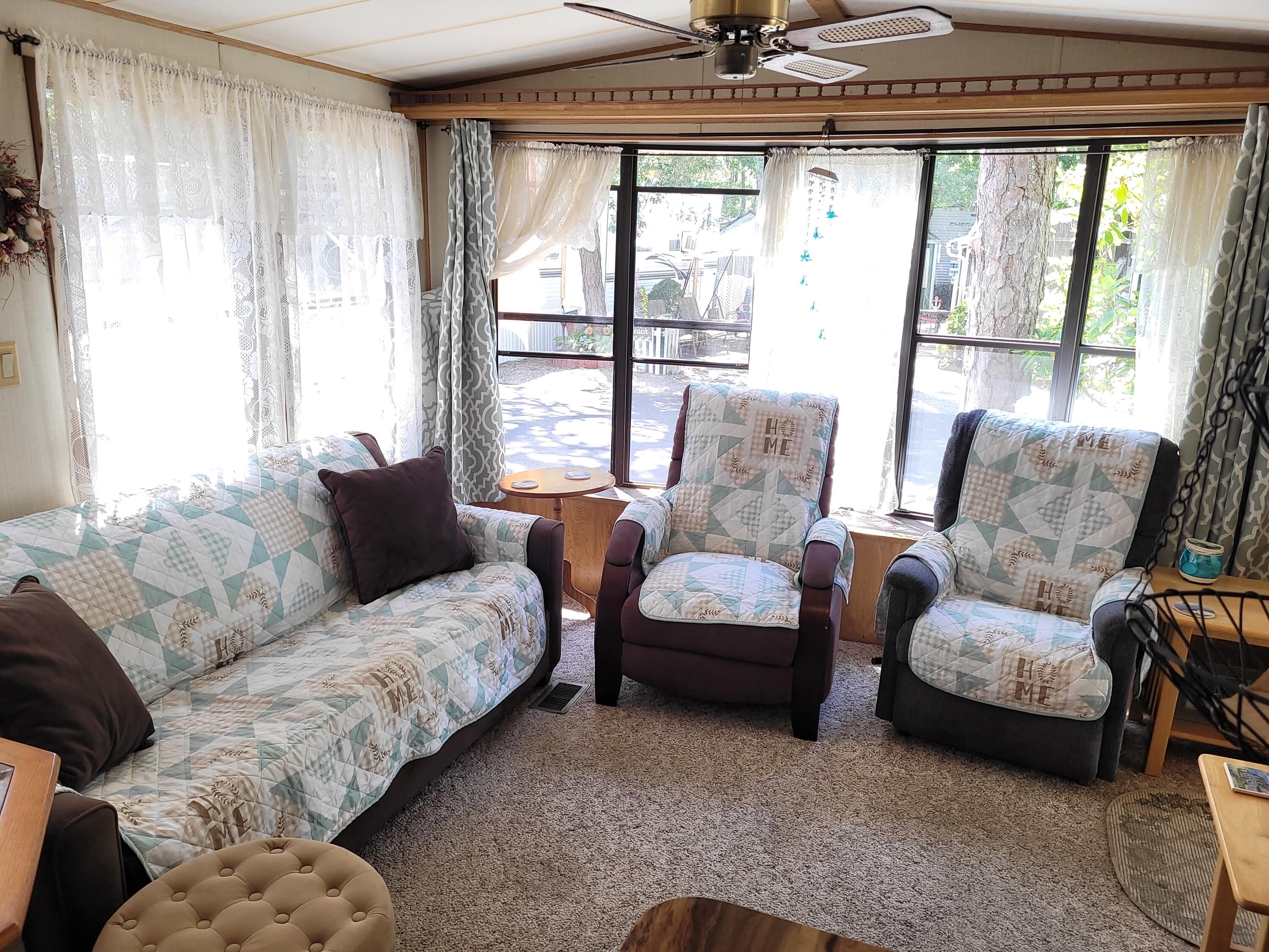 310 Old Chatham Road, Unit H12 South Dennis, MA 02660 - Photo 29 of 55 a living room with furniture and a large window