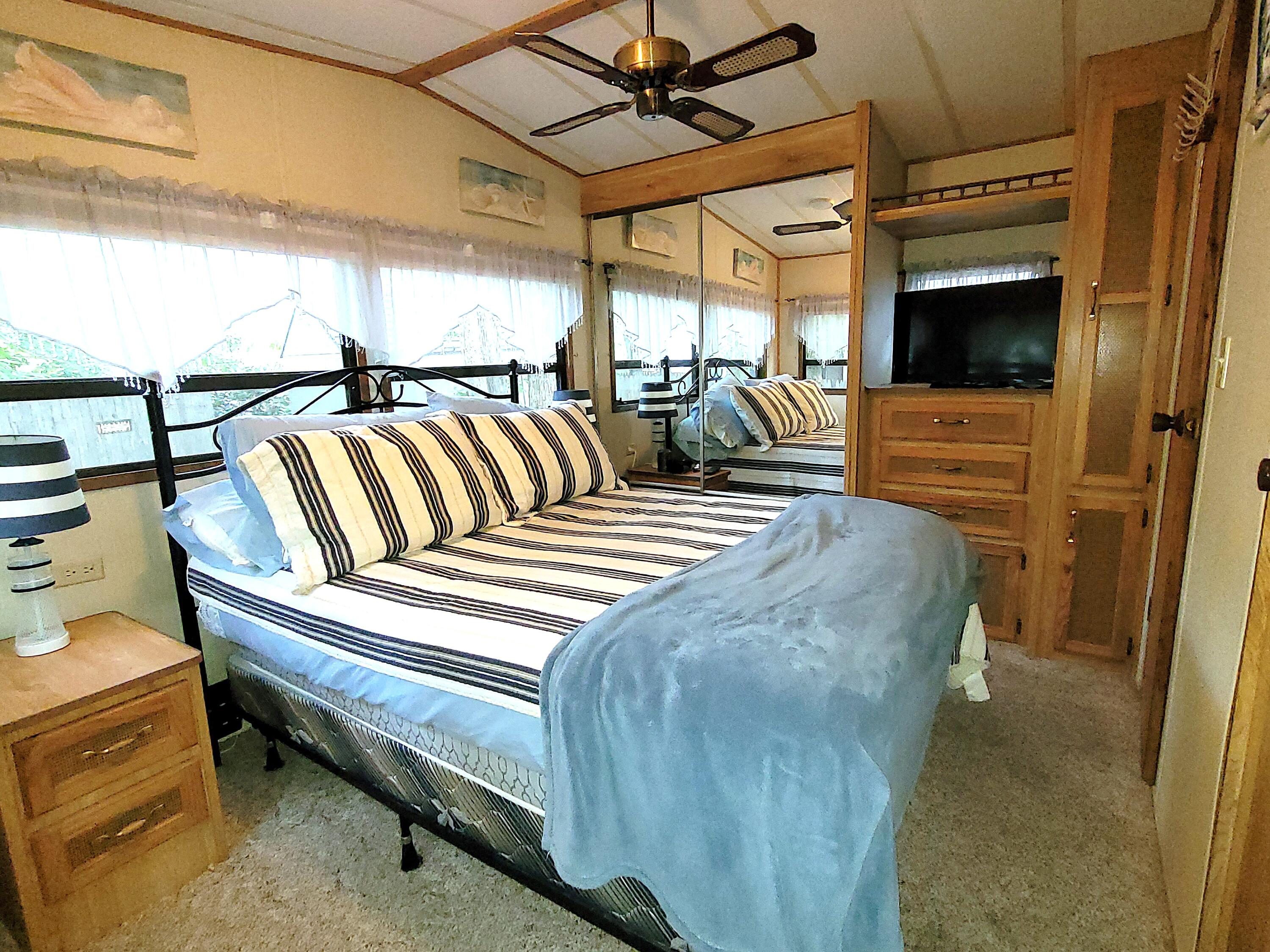 310 Old Chatham Road, Unit H12 South Dennis, MA 02660 - Photo 3 of 55 a bedroom with a bed a flat screen tv and balcony