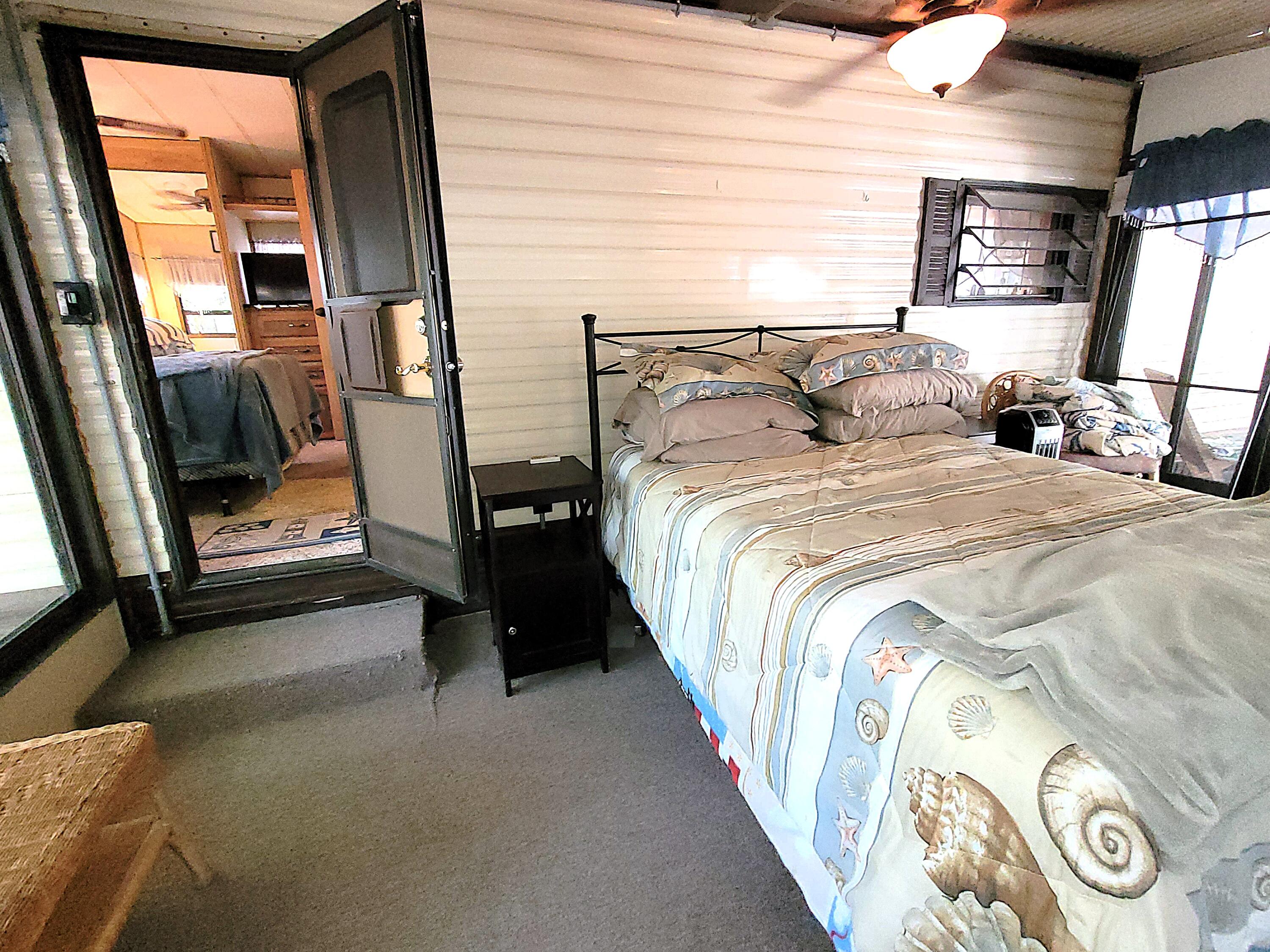 310 Old Chatham Road, Unit H12 South Dennis, MA 02660 - Photo 35 of 55 a bedroom with a bed and a mirror
