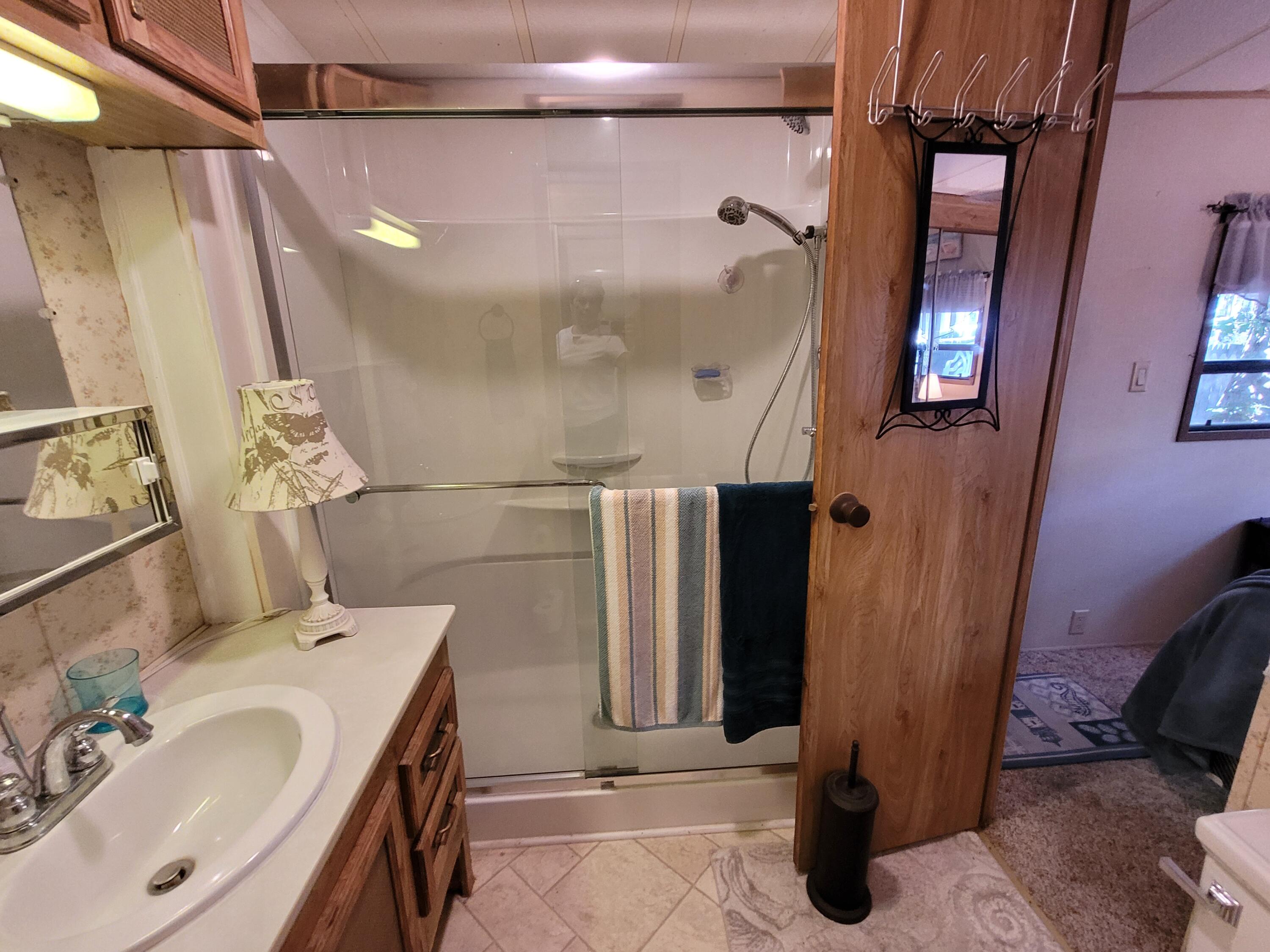 310 Old Chatham Road, Unit H12 South Dennis, MA 02660 - Photo 40 of 55 a bathroom with a sink a mirror and shower