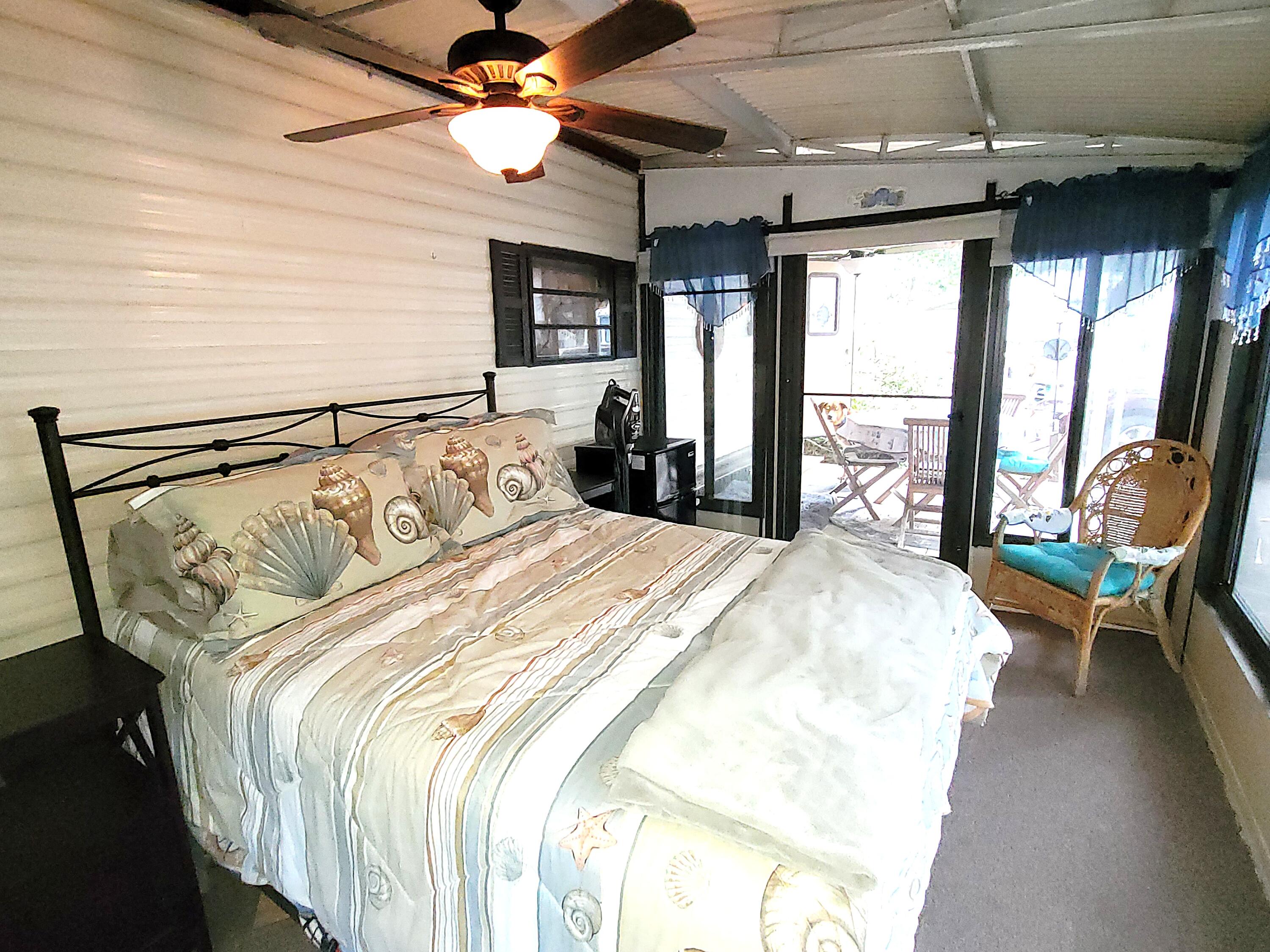 310 Old Chatham Road, Unit H12 South Dennis, MA 02660 - Photo 4 of 55 a bedroom with a bed next to a window with a flat tv screen