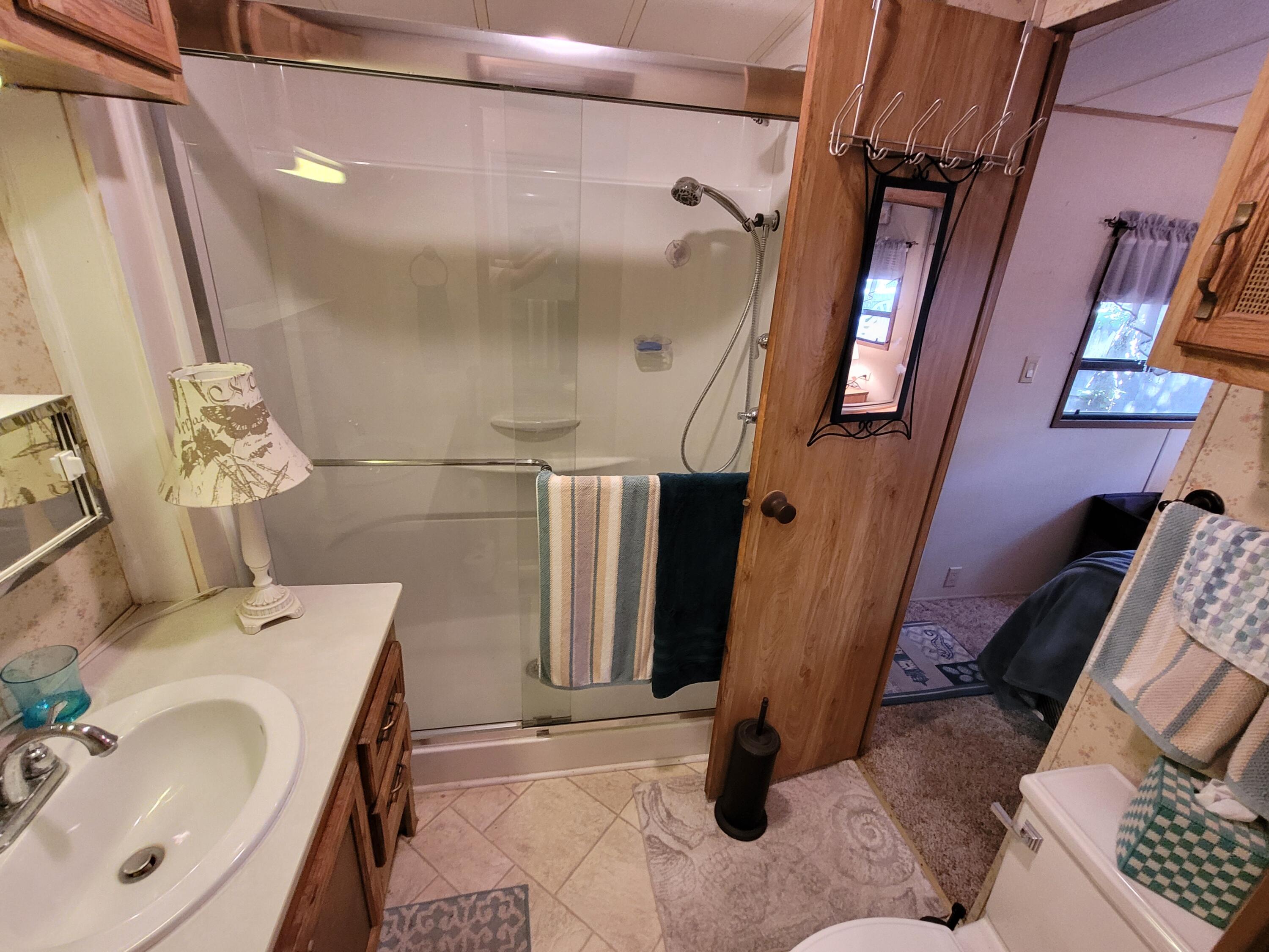 310 Old Chatham Road, Unit H12 South Dennis, MA 02660 - Photo 41 of 55 a bathroom with a sink and mirror with bathtub