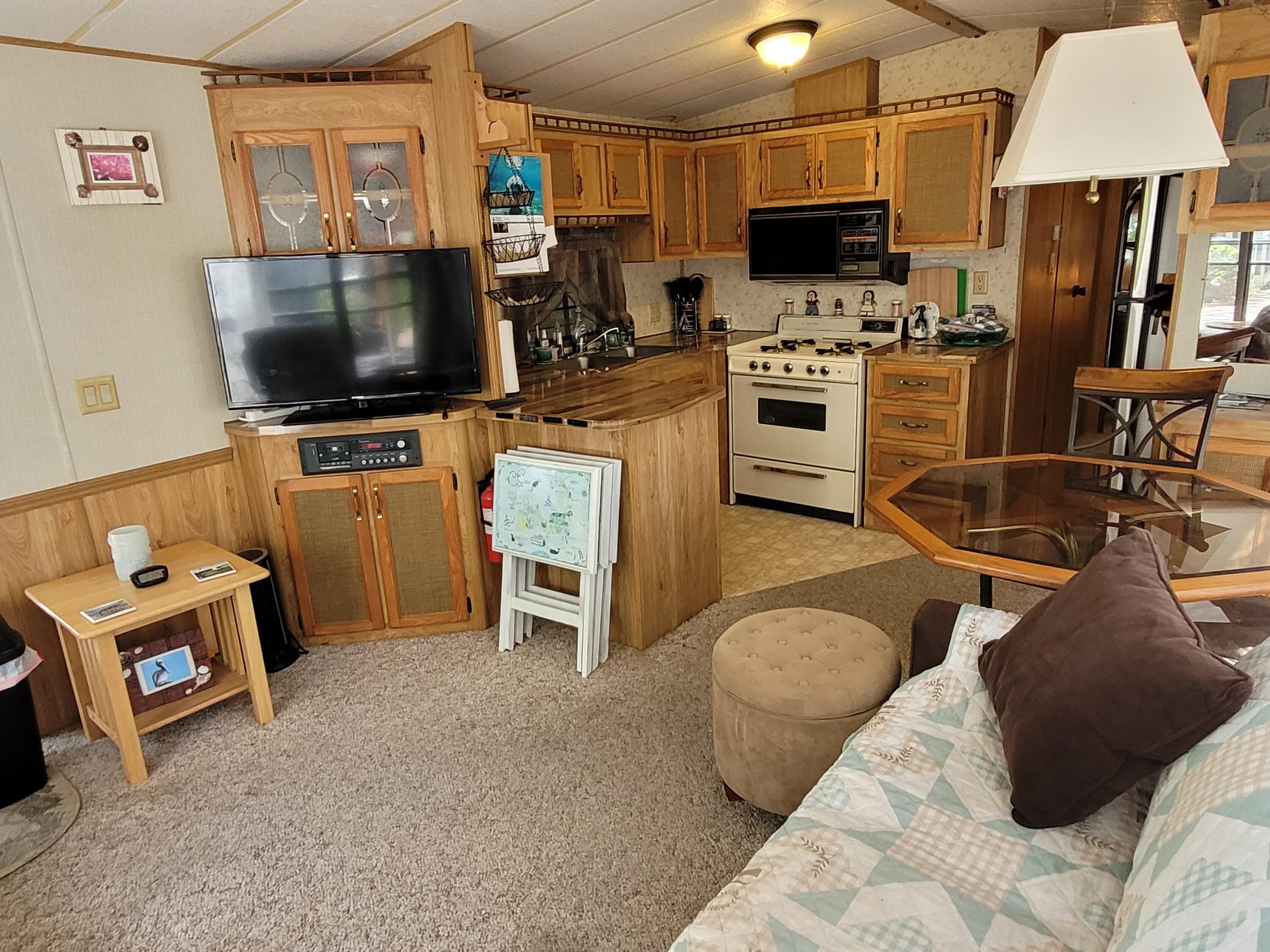 310 Old Chatham Road, Unit H12 South Dennis, MA 02660 - Photo 50 of 55 a living room with furniture and a flat screen tv