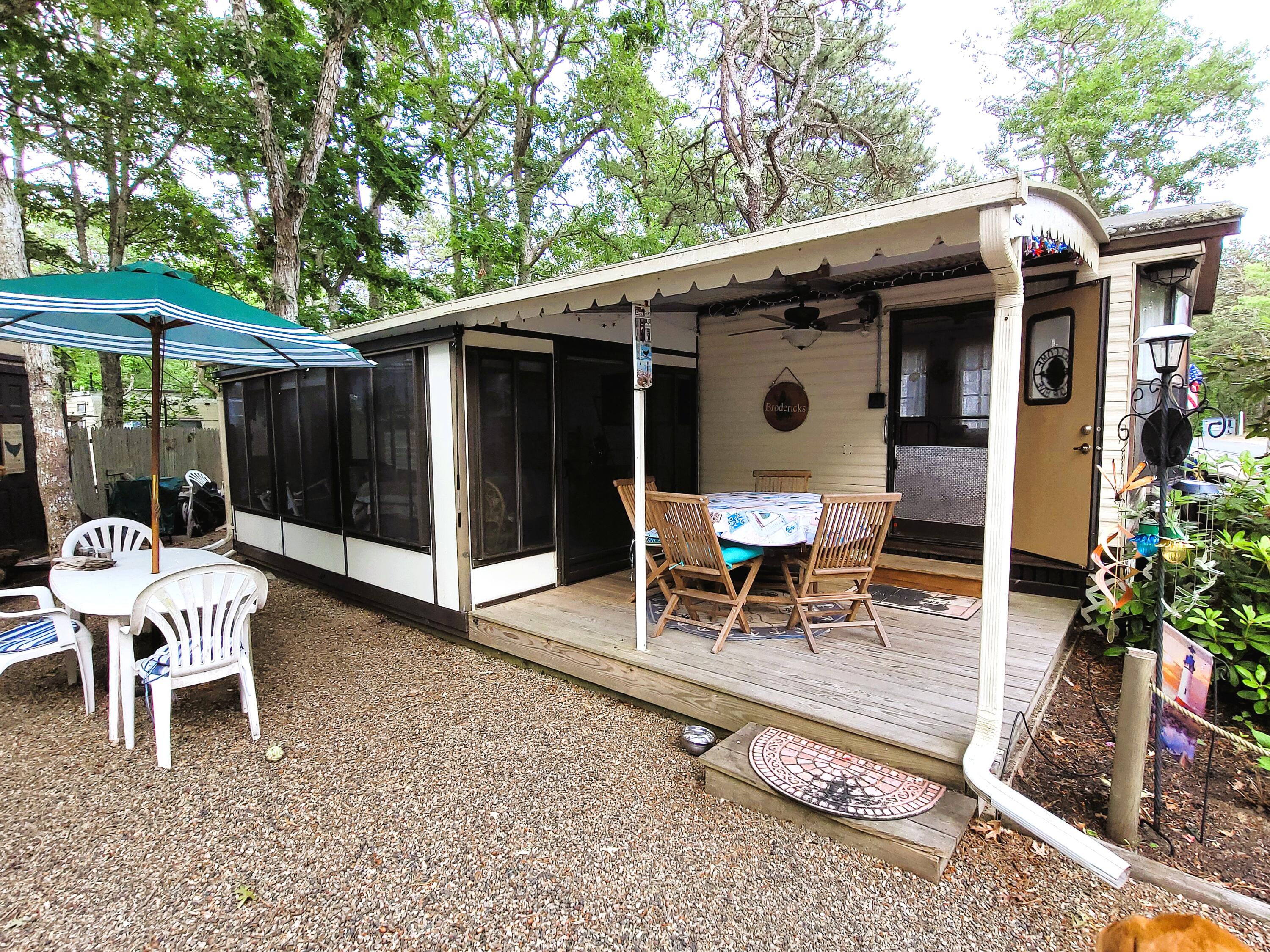 310 Old Chatham Road, Unit H12 South Dennis, MA 02660 - Photo 7 of 55 a patio with table and chairs