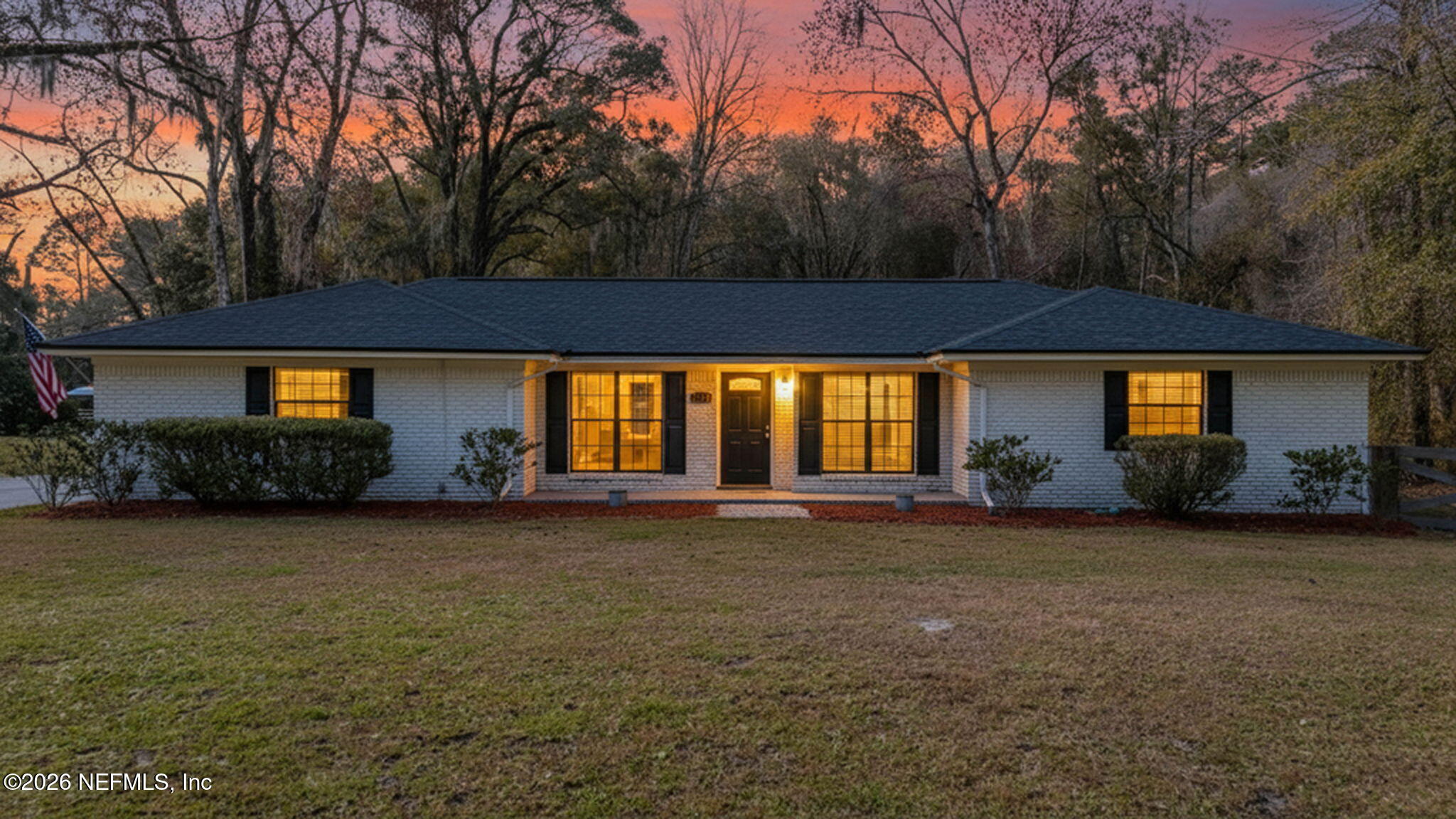 a front view of a house with a garden