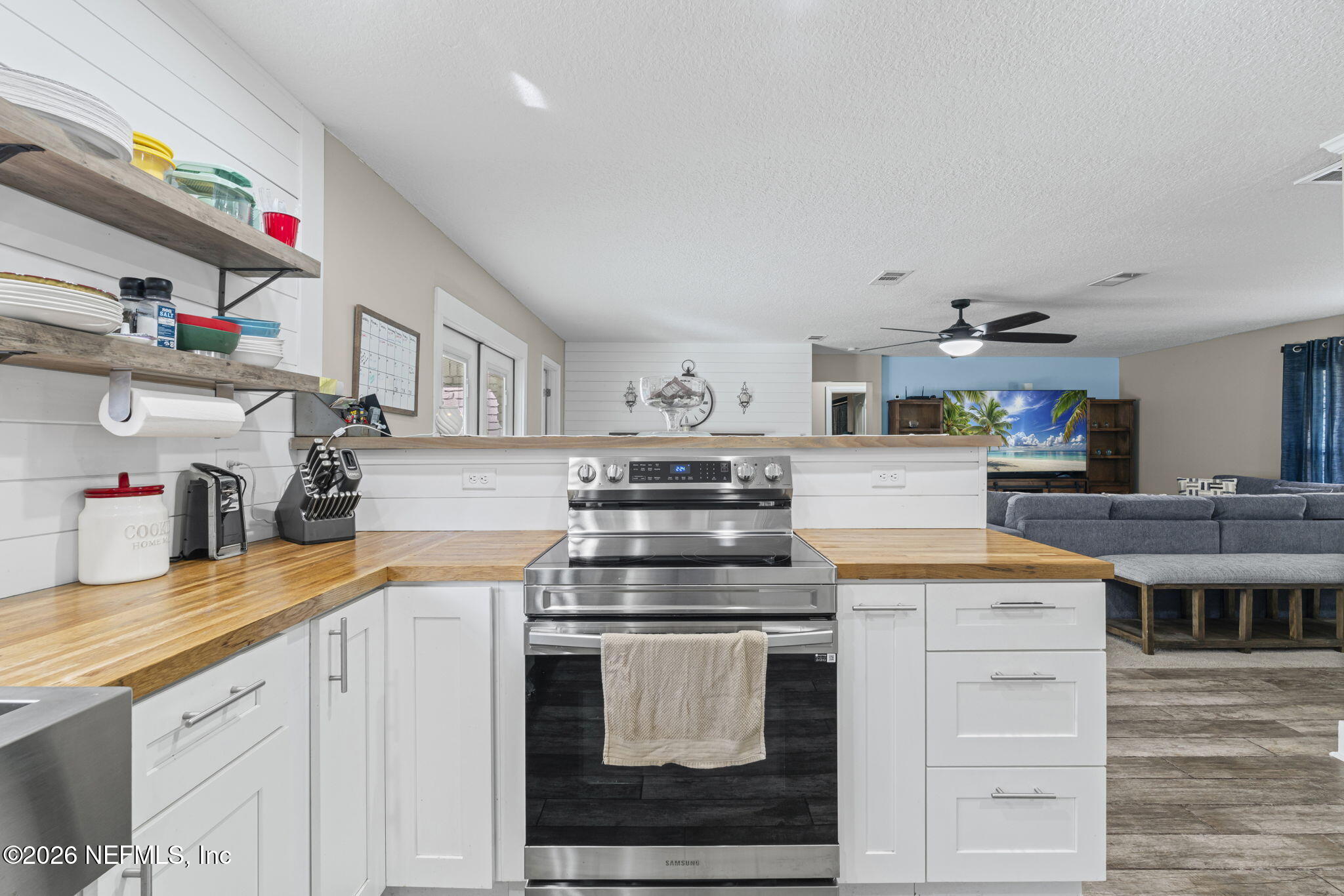 3084 Joe Johns Road Middleburg, FL 32068 - Photo 14 of 52 a kitchen with stainless steel appliances granite countertop a stove and white cabinets