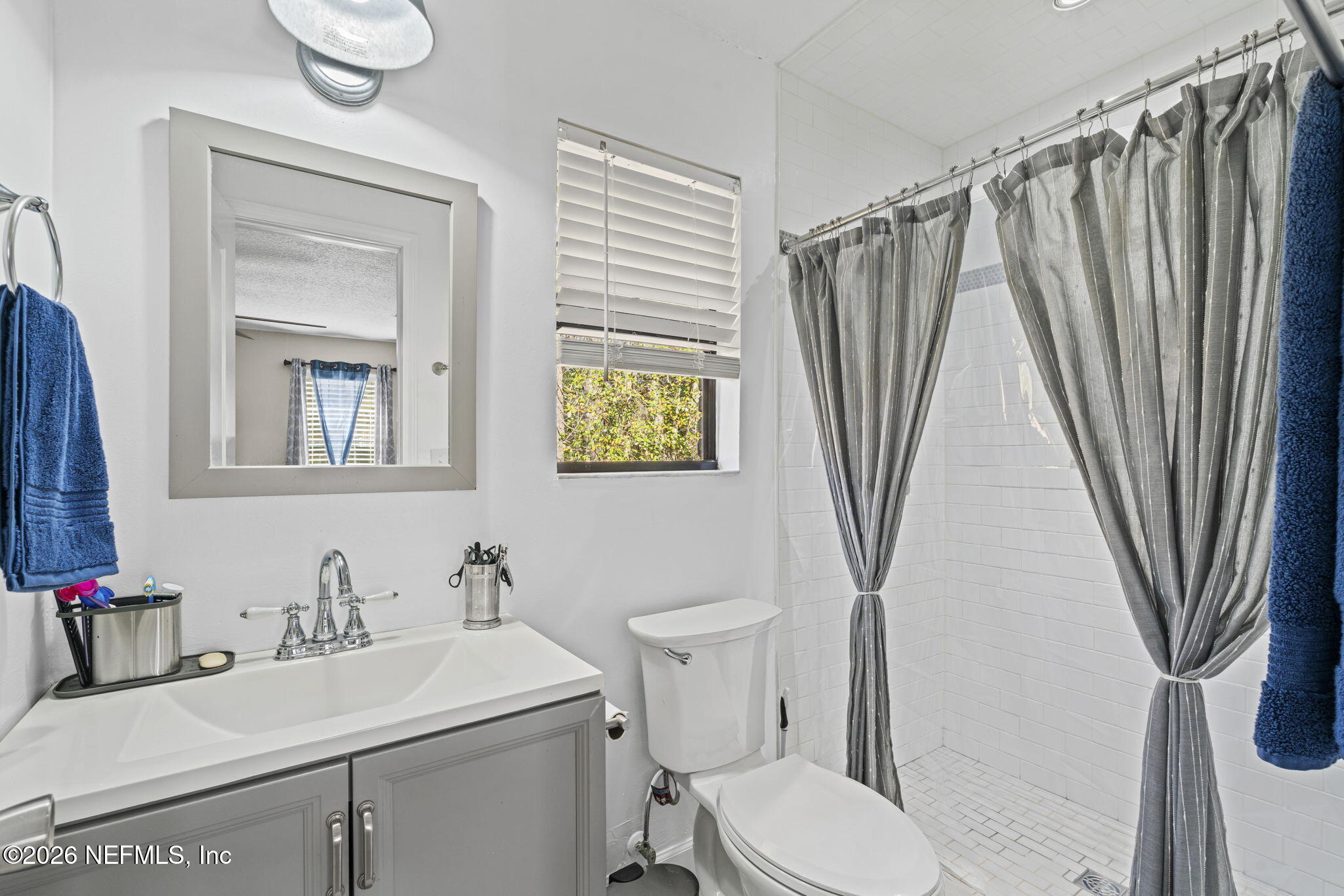 3084 Joe Johns Road Middleburg, FL 32068 - Photo 20 of 52 a bathroom with a sink a toilet and a mirror
