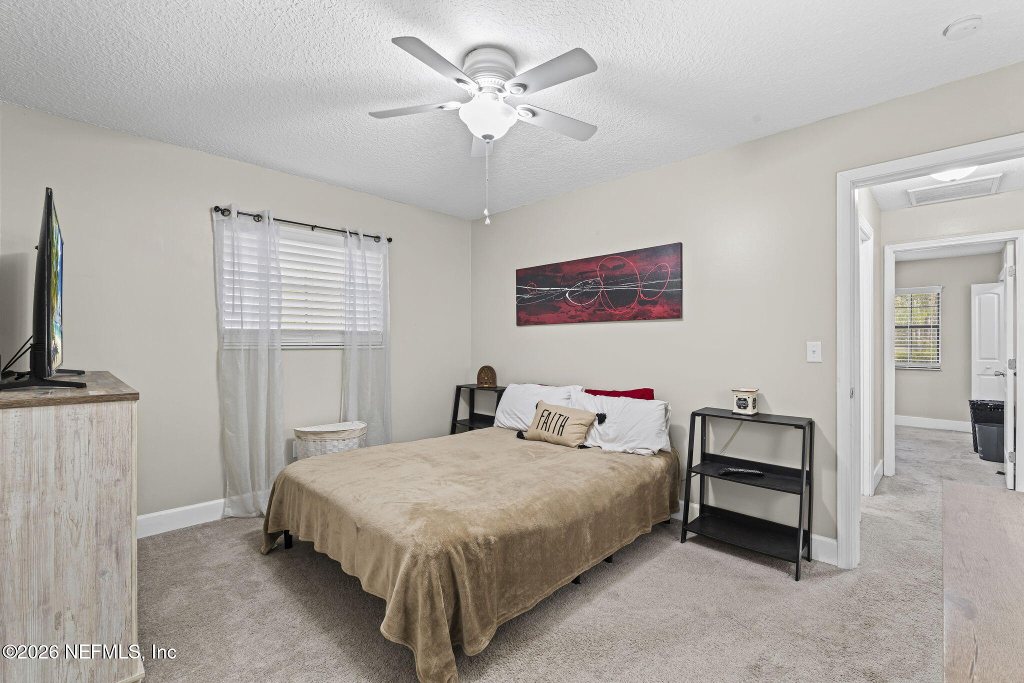 3084 Joe Johns Road Middleburg, FL 32068 - Photo 21 of 52 a bedroom with a bed and a chandelier