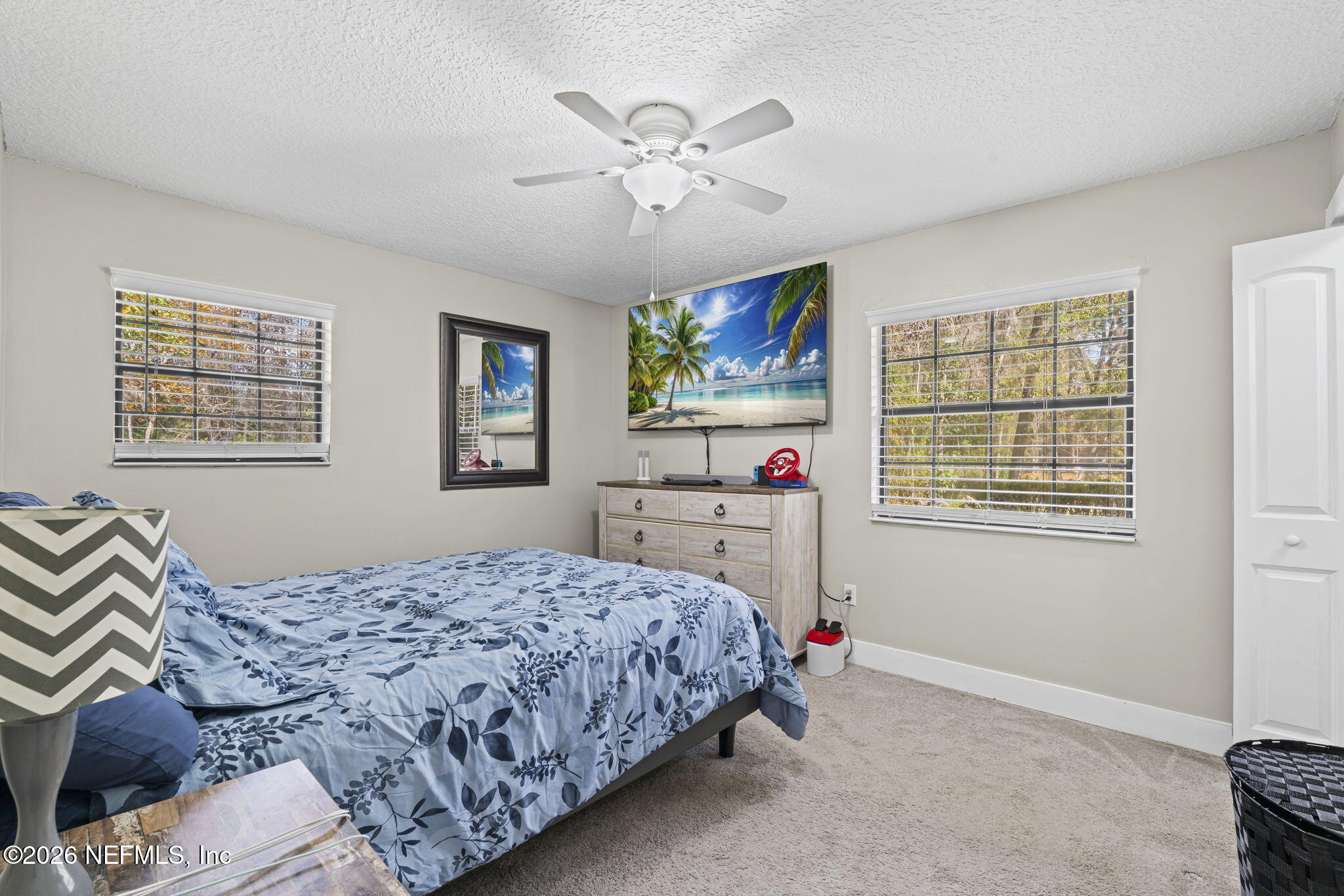 3084 Joe Johns Road Middleburg, FL 32068 - Photo 23 of 52 a bedroom with a bed and a chandelier