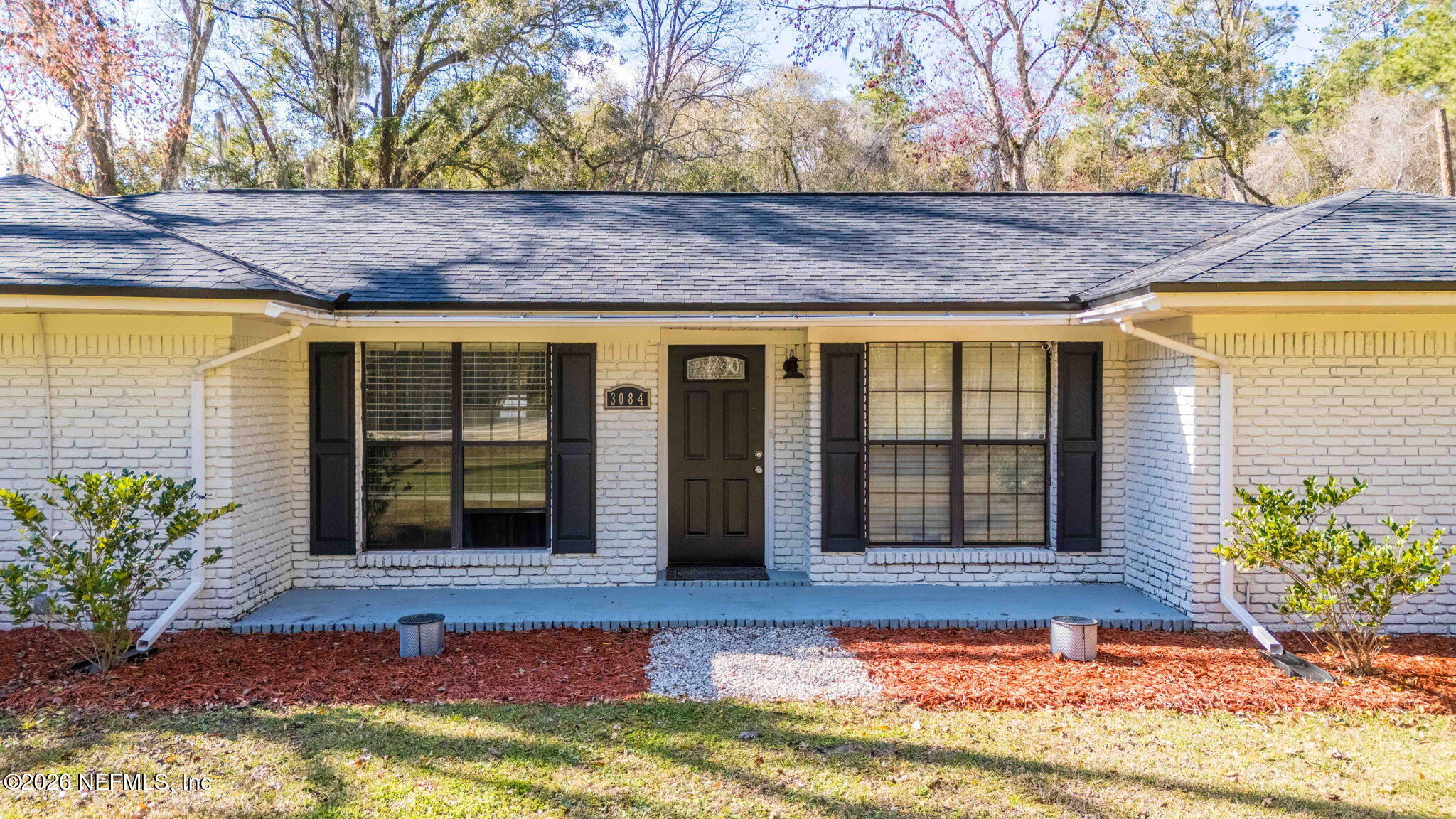 3084 Joe Johns Road Middleburg, FL 32068 - Photo 3 of 52 a front view of a house with a large window and potted plants