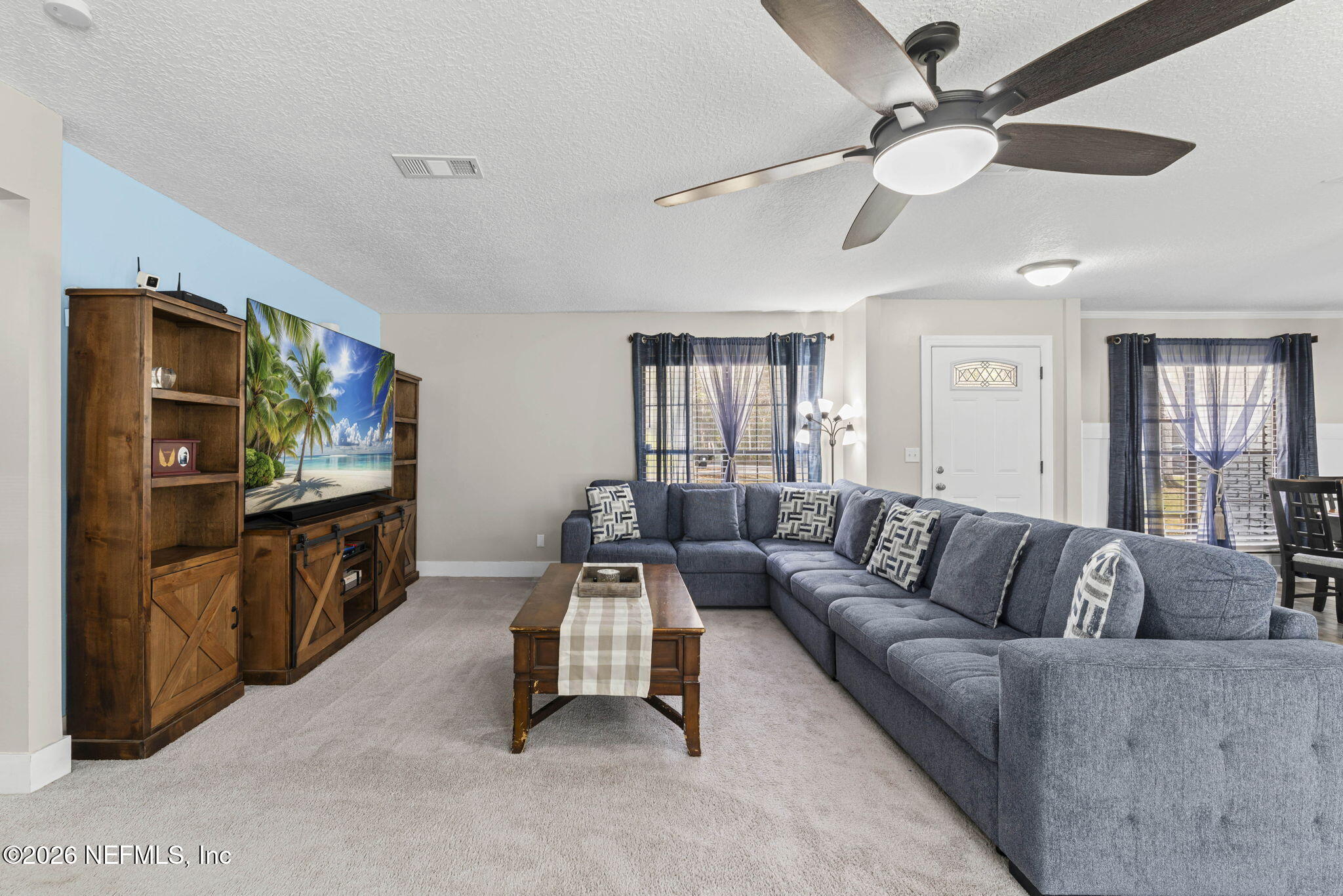 3084 Joe Johns Road Middleburg, FL 32068 - Photo 9 of 52 a living room with furniture and a flat screen tv