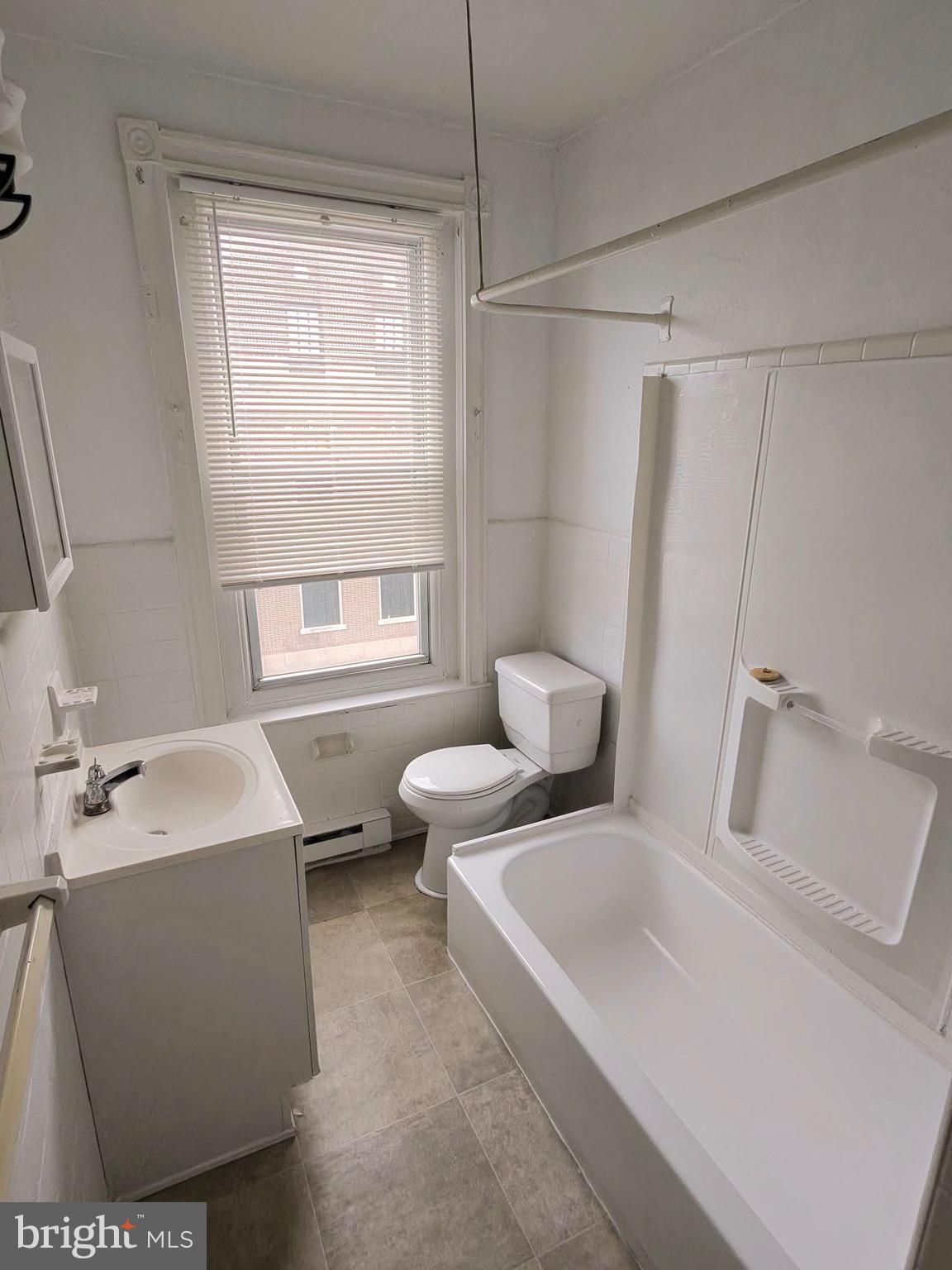 5700 Chestnut Street, Unit 3A Philadelphia, PA 19139 - Photo 4 of 8 a bathroom with a sink and a toilet