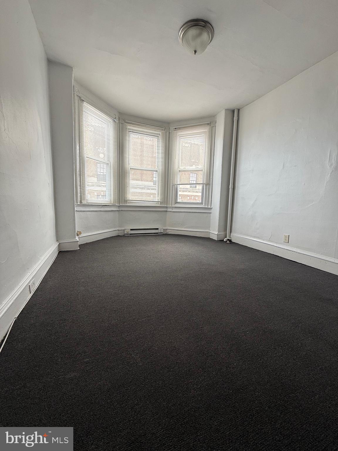 5700 Chestnut Street, Unit 3A Philadelphia, PA 19139 - Photo 5 of 8 an empty room with a window