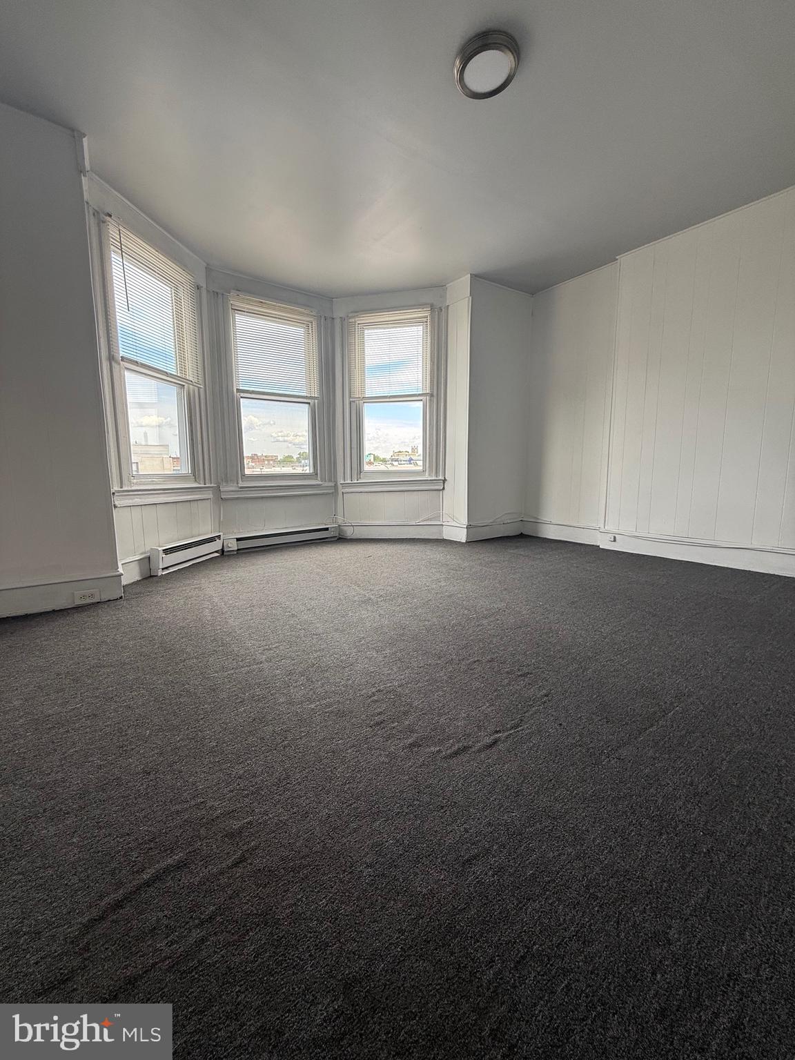 5700 Chestnut Street, Unit 3A Philadelphia, PA 19139 - Photo 6 of 8 an empty room with windows