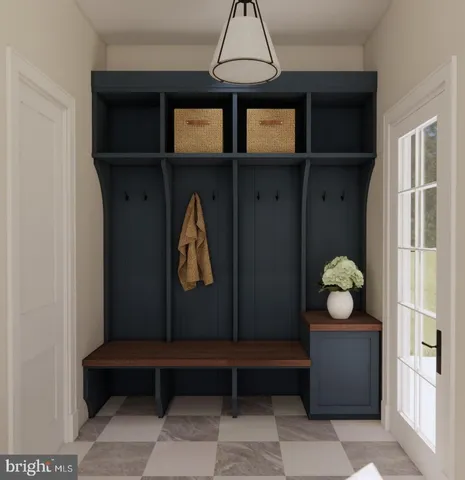 a bedroom with a bed a chandelier and mirror