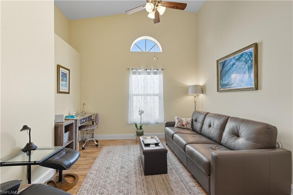 2266 Stacil Circle, Unit 3 Naples, FL 34109 - Photo 14 of 49 Living area with wood finished floors, high vaulted ceiling, and a ceiling fan