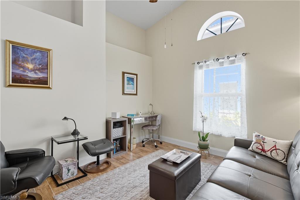 2266 Stacil Circle, Unit 3 Naples, FL 34109 - Photo 15 of 49 Living room with wood finished floors, ceiling fan, a high ceiling, and a desk