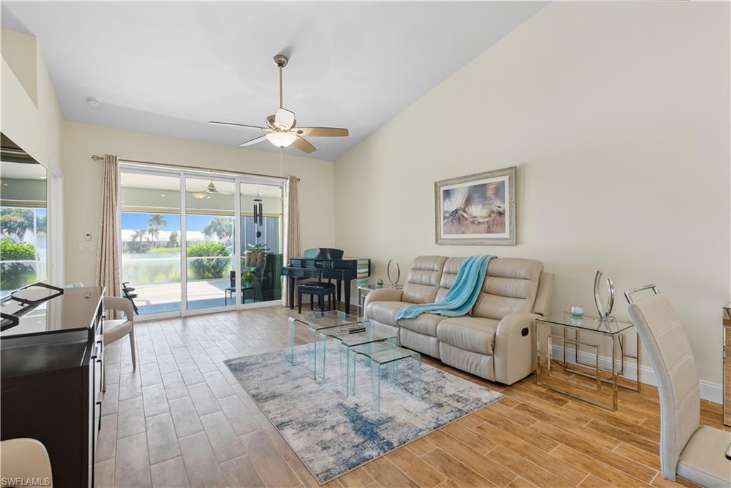 2266 Stacil Circle, Unit 3 Naples, FL 34109 - Photo 17 of 49 Living room featuring lofted ceiling, wood finish floors, ceiling fan, and a water view