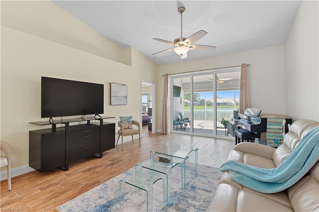 2266 Stacil Circle, Unit 3 Naples, FL 34109 - Photo 19 of 49 Living room featuring wood tiled floors, ceiling fan, and lofted ceiling