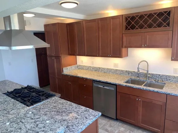 a kitchen with wooden cabinets and a sink