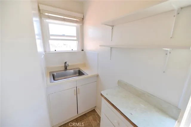a kitchen with white cabinets and white appliances
