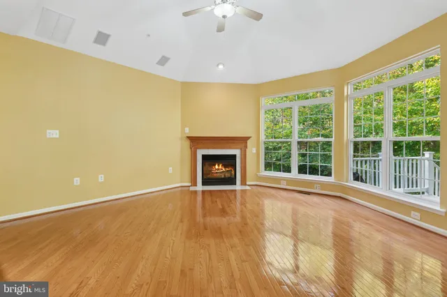 a view of a kitchen with furniture and wooden floor