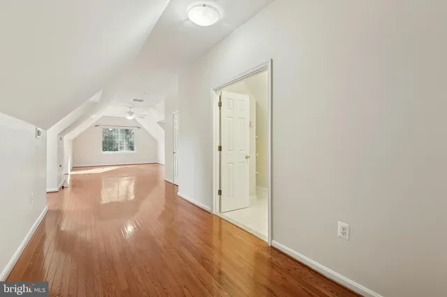 a bathroom with a bathtub sink vanity mirror and toilet