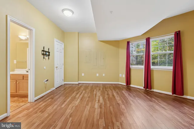 a view of a living room hardwood floor and a kitchen