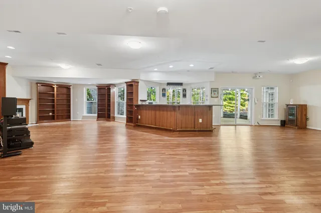 a view of a kitchen with furniture and wooden floor