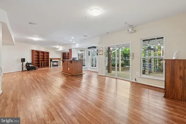 a view of an empty room with a fireplace and a window