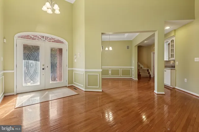 a living room with wooden floor and a fireplace