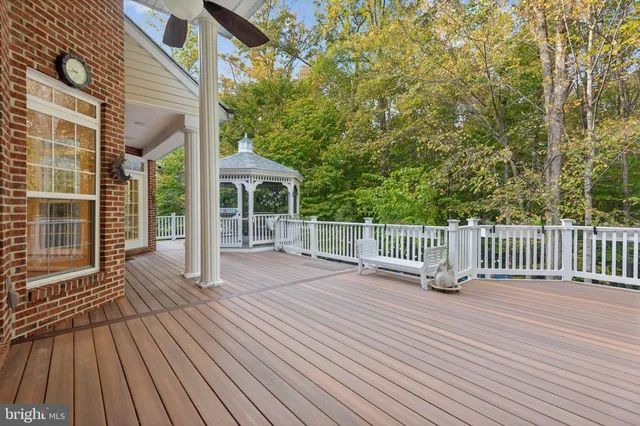 a view of a patio with couches and table and chairs next to window