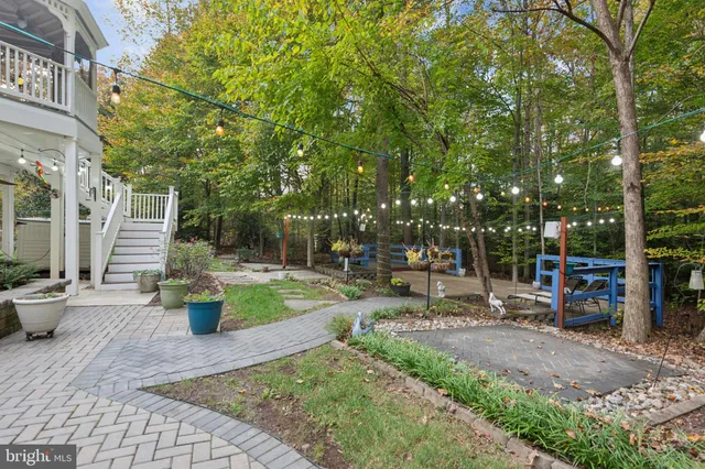a view of a building with a garden and sitting area
