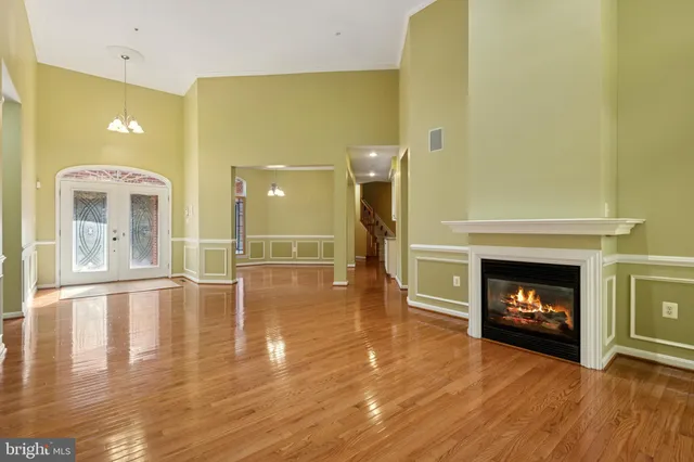 a kitchen with a sink a stove cabinets and wooden floor