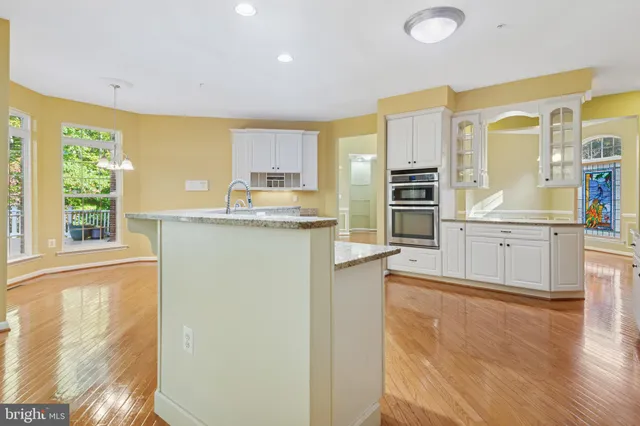 a large white kitchen with a large window