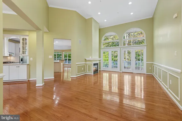 a large kitchen with cabinets wooden floor and a granite counter top