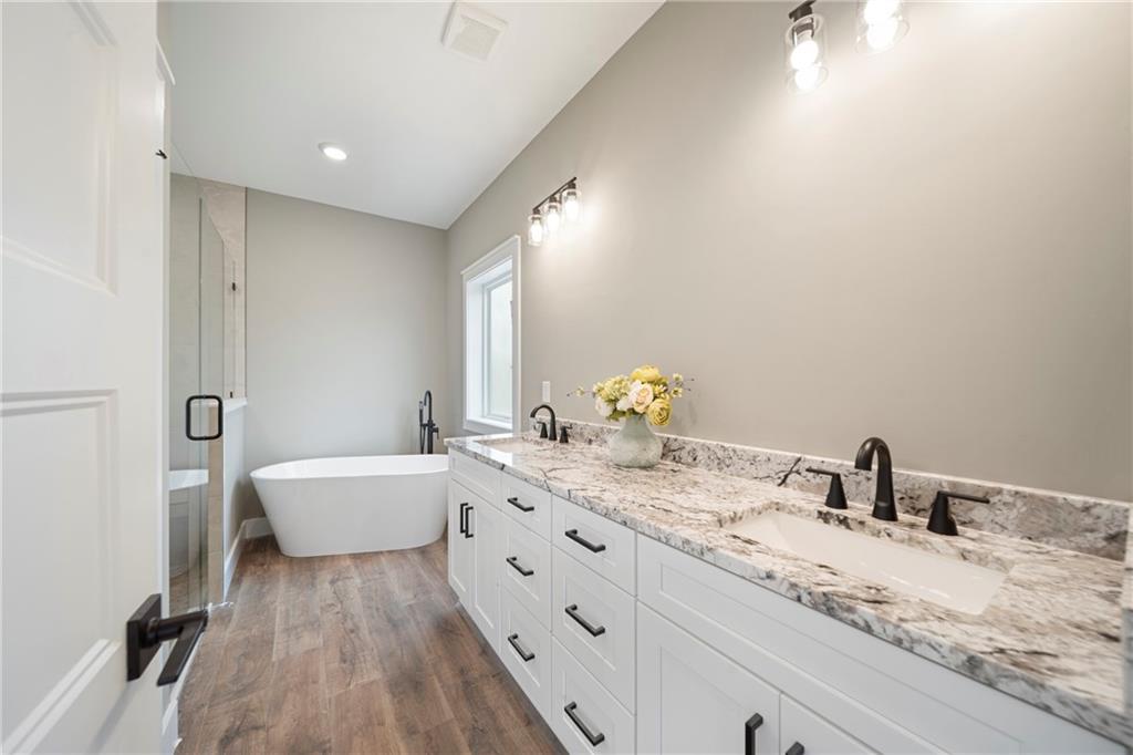 2956 Blalock Mountain Road Talking Rock, GA 30175 - Photo 19 of 65 a bathroom with a granite countertop sink mirror and bathtub