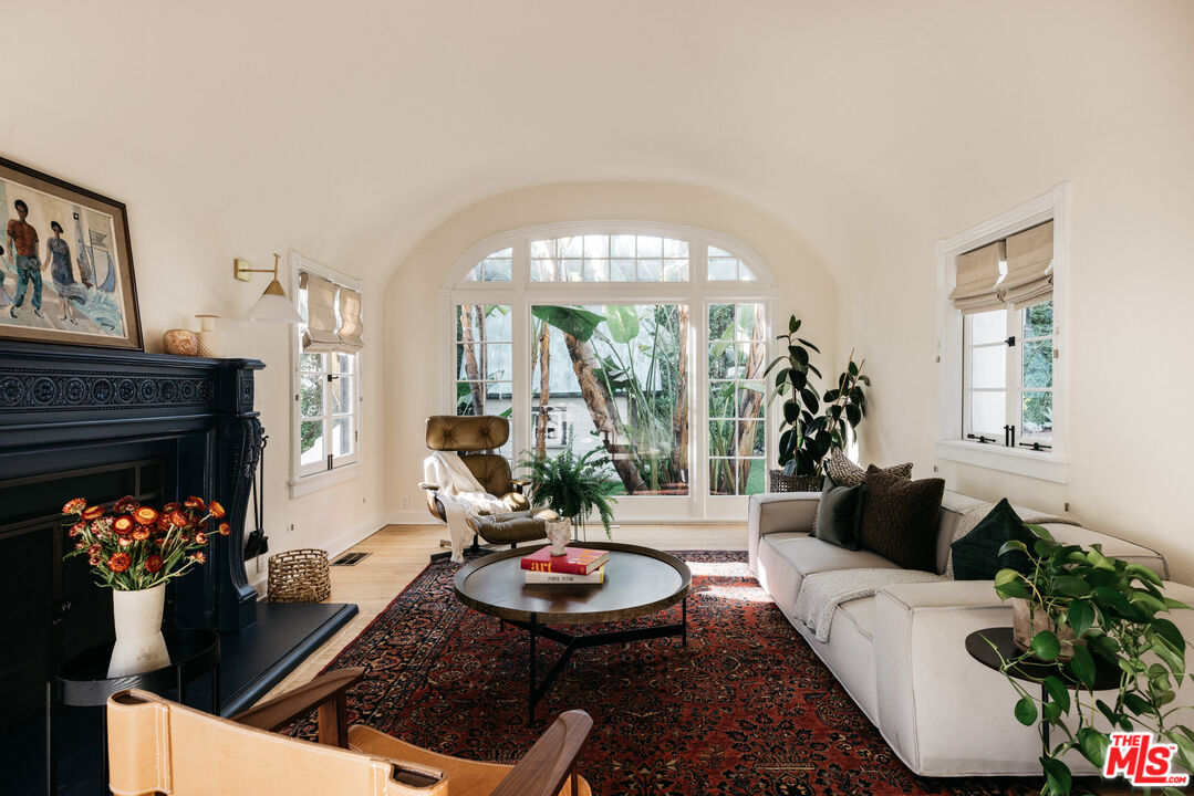 3216 Lowry Road Los Angeles, CA 90027 - Photo 1 of 54 a living room with fireplace furniture and a large window