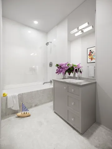 a bathroom with a sink mirror and vanity
