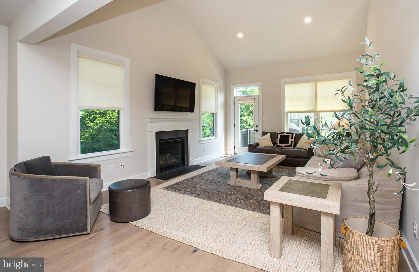 21 The Lane Wayne, PA 19087 - Photo 12 of 57 a living room with furniture a flat screen tv and a fireplace