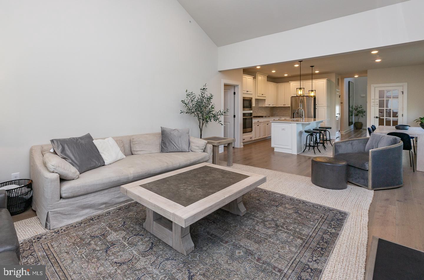 21 The Lane Wayne, PA 19087 - Photo 15 of 57 a living room with furniture wooden floor and a rug