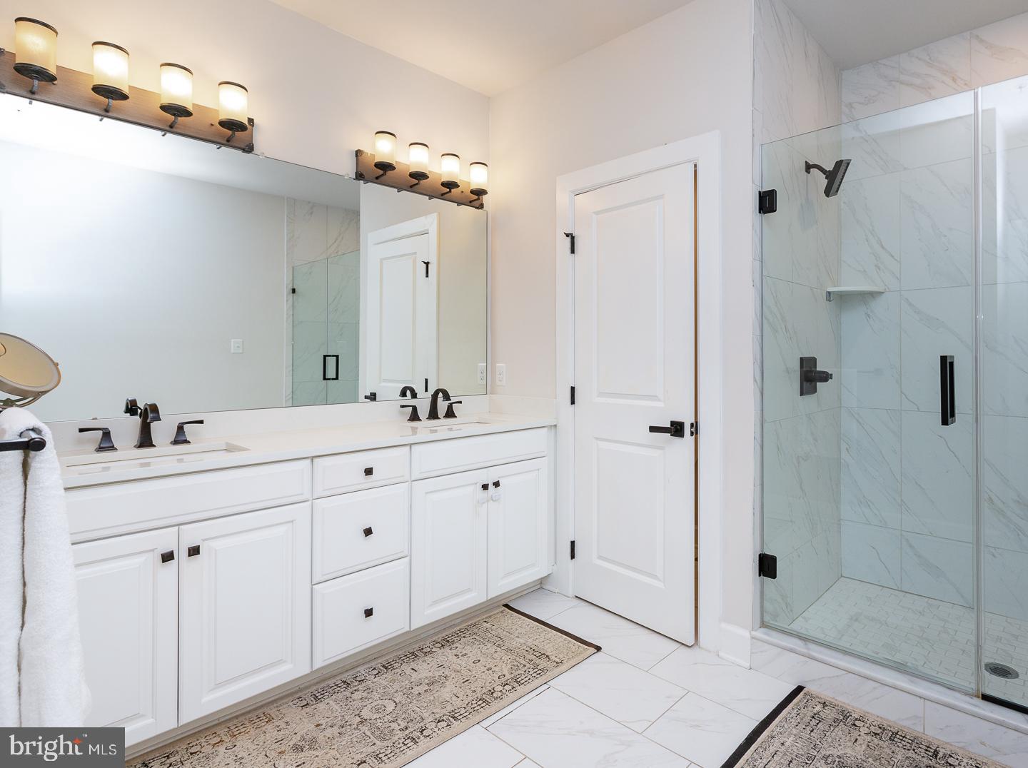 21 The Lane Wayne, PA 19087 - Photo 21 of 57 a spacious bathroom with double sink and a mirror